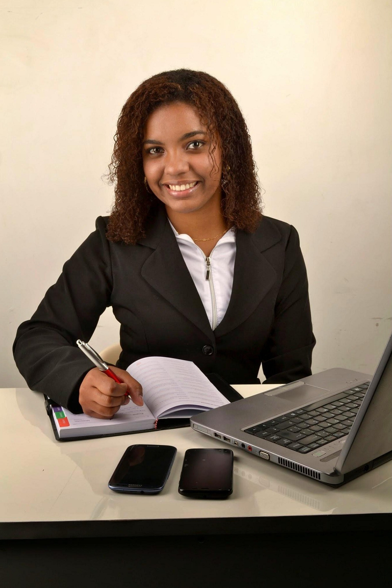 woman in a suit working in front of a laptop